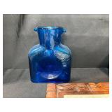 Eclectic Decorative Collection with Blue Glass Bottles, Plates, Wood Dish, and Longaberger Basket