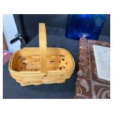 Eclectic Decorative Collection with Blue Glass Bottles, Plates, Wood Dish, and Longaberger Basket