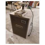 Tool shop drill press mounted to a metal cabinet