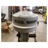 Tool shop drill press mounted to a metal cabinet
