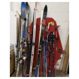 Lots of snow skis, poles down hill and cross country