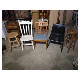 Lot of Chairs and Stools including White Spindle-Back Chair, Wooden Chair with Blue Cushion, Black Plastic Chair, and Wooden Bar Stool