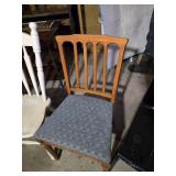 Lot of Chairs and Stools including White Spindle-Back Chair, Wooden Chair with Blue Cushion, Black Plastic Chair, and Wooden Bar Stool