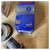 Automotive Parts Collection including BrakeBest Brake Shoes, Motorcraft Spark Plugs (SP-486), and NAPA Thermostat, Halogen headlamp (type HB1 9004).