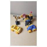 Toy construction vehicles including a toy backhoe loader, yellow toy car, and blue toy car