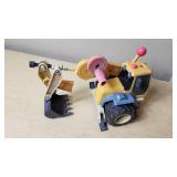 Toy construction vehicles including a toy backhoe loader, yellow toy car, and blue toy car