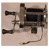 LL-FR - Pair of Fishing Reels Including Johnson Spincast and Conventional Reel