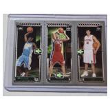 2003-04 Topps Rookie Matrix basketball trading card featuring LeBron James, Carmelo Anthony, and either Darko Milicic or Chris Kaman