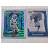 Lot of 2 Amon-Ra St. Brown Football Cards Featuring Prizm Emergent Refractor and Chronicles Playoff Momentum Rookie Cards