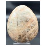 A graceful Peach Moonstone freeform, glowing with soft, warm hues of apricot and cream and flashes in the sunlight.