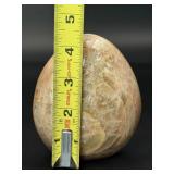 A graceful Peach Moonstone freeform, glowing with soft, warm hues of apricot and cream and flashes in the sunlight.