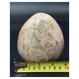 A graceful Peach Moonstone freeform, glowing with soft, warm hues of apricot and cream and flashes in the sunlight.