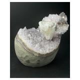 A stunning Amethyst crystal perched on its natural matrix, featuring delicate Calcite inclusions that add depth and character.