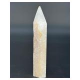 A delicate druzy Golden Healer quartz tower sparkling with a natural crust of tiny crystals atop warm golden tones. Slender and radiant, it amplifies healing, light.