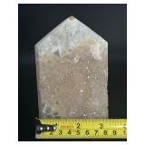 A delicate druzy Golden Healer quartz tower sparkling with a natural crust of tiny crystals atop warm golden tones. Slender and radiant, it amplifies healing, light.