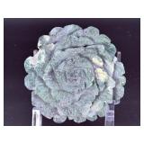 A hand-carved flower crafted from natural moss agate, showcasing intricate petal details and the stone’s unique green and earthy inclusions.