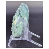 A hand-carved flower crafted from natural moss agate, showcasing intricate petal details and the stone’s unique green and earthy inclusions.