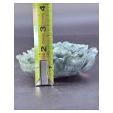 A hand-carved flower crafted from natural moss agate, showcasing intricate petal details and the stone’s unique green and earthy inclusions.