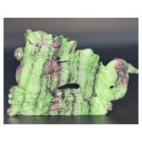 A striking hand-carved dragon sculpted from natural ruby zoisite, showcasing vibrant green and deep red tones.