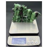 A striking hand-carved dragon sculpted from natural ruby zoisite, showcasing vibrant green and deep red tones.