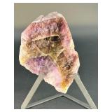 A vibrant Super 7 slice showcasing the unique combination of seven powerful minerals—amethyst, cacoxenite, goethite, lepidocrocite, rutile, smoky quartz, and clear quartz.