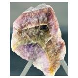 A vibrant Super 7 slice showcasing the unique combination of seven powerful minerals—amethyst, cacoxenite, goethite, lepidocrocite, rutile, smoky quartz, and clear quartz.