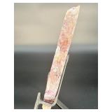 A vibrant Super 7 slice showcasing the unique combination of seven powerful minerals—amethyst, cacoxenite, goethite, lepidocrocite, rutile, smoky quartz, and clear quartz.