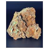 A delicate carbonate mineral of zinc and copper, displaying soft hues of pale blue to green‑blue in fine acicular (needle‑like) crystal sprays or tufted clusters.