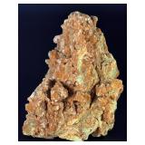 A delicate carbonate mineral of zinc and copper, displaying soft hues of pale blue to green‑blue in fine acicular (needle‑like) crystal sprays or tufted clusters.