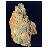 A delicate carbonate mineral of zinc and copper, displaying soft hues of pale blue to green‑blue in fine acicular (needle‑like) crystal sprays or tufted clusters.