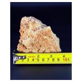 A delicate carbonate mineral of zinc and copper, displaying soft hues of pale blue to green‑blue in fine acicular (needle‑like) crystal sprays or tufted clusters.