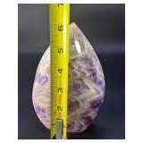A Chevron Amethyst Freeform is a beautiful, naturally shaped crystal that features striking V-shaped banding of deep purple amethyst and milky white quartz. Also known as Dream Amethyst,