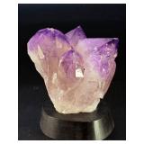 An Elestial Amethyst Cluster is a rare and powerful crystal formation celebrated for its intricate, layered growth and deep spiritual energy.