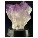An Elestial Amethyst Cluster is a rare and powerful crystal formation celebrated for its intricate, layered growth and deep spiritual energy.