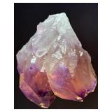 An Elestial Amethyst Cluster is a rare and powerful crystal formation celebrated for its intricate, layered growth and deep spiritual energy.