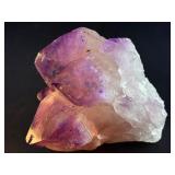 An Elestial Amethyst Cluster is a rare and powerful crystal formation celebrated for its intricate, layered growth and deep spiritual energy.