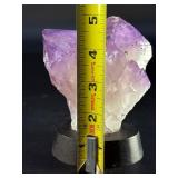 An Elestial Amethyst Cluster is a rare and powerful crystal formation celebrated for its intricate, layered growth and deep spiritual energy.