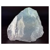 A Blue Raw Fluorite piece showcases the crystal in its natural, unpolished state, highlighting its geometric formations and soft to vibrant blue hues.