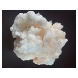 Peach Stilbite is a delicate and captivating crystal known for its soft, peachy-pink color and intricate, fan-like formations. Often found in clusters, the crystal’s radiating, layered structures ca