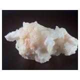 Peach Stilbite is a delicate and captivating crystal known for its soft, peachy-pink color and intricate, fan-like formations. Often found in clusters, the crystal’s radiating, layered structures ca