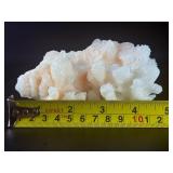 Peach Stilbite is a delicate and captivating crystal known for its soft, peachy-pink color and intricate, fan-like formations. Often found in clusters, the crystal’s radiating, layered structures ca