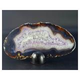 Banded Amethyst Agate (Polished) is a stunning crystal piece that combines the deep, rich purples of amethyst with the layered, earthy tones of agate.