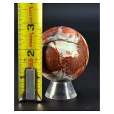 Laguna Lace Agate Sphere is a mesmerizing crystal sphere that highlights the intricate, lace-like banding unique to Laguna Agate.