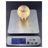 Moonstone Sphere with Blue Flashes is a captivating crystal sphere known for its soft, luminous glow and stunning blue flashes that shimmer as the light moves across its surface.