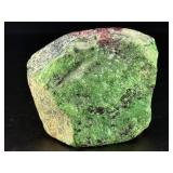 Ruby Zoisite is a striking natural stone that beautifully blends vibrant ruby inclusions with earthy green zoisite, often accented by dark hornblende veins.
