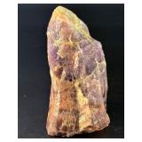 Raw Chevron Amethyst showcases the stone in its natural, unpolished form, highlighting bold V-shaped bands of deep purple amethyst and milky white quartz.