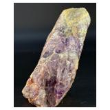 Raw Chevron Amethyst showcases the stone in its natural, unpolished form, highlighting bold V-shaped bands of deep purple amethyst and milky white quartz.