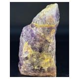 Raw Chevron Amethyst showcases the stone in its natural, unpolished form, highlighting bold V-shaped bands of deep purple amethyst and milky white quartz.