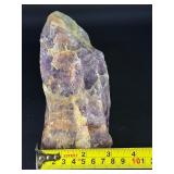 Raw Chevron Amethyst showcases the stone in its natural, unpolished form, highlighting bold V-shaped bands of deep purple amethyst and milky white quartz.