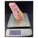 Raw Chevron Amethyst showcases the stone in its natural, unpolished form, highlighting bold V-shaped bands of deep purple amethyst and milky white quartz.